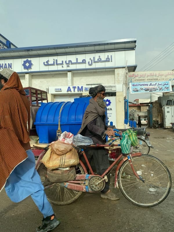Two men observed on Kandahar street under overcast skies