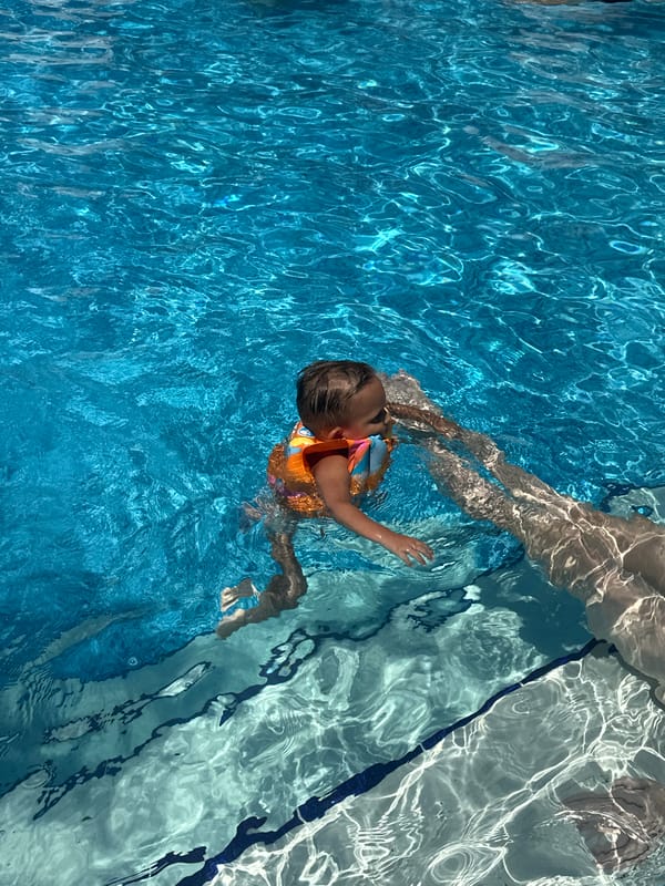Sunny pool day in Sochi with swimmers and kids in the water