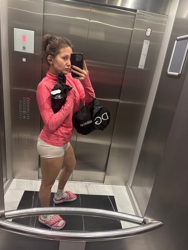 Woman takes elevator selfie in athletic wear in Dubai