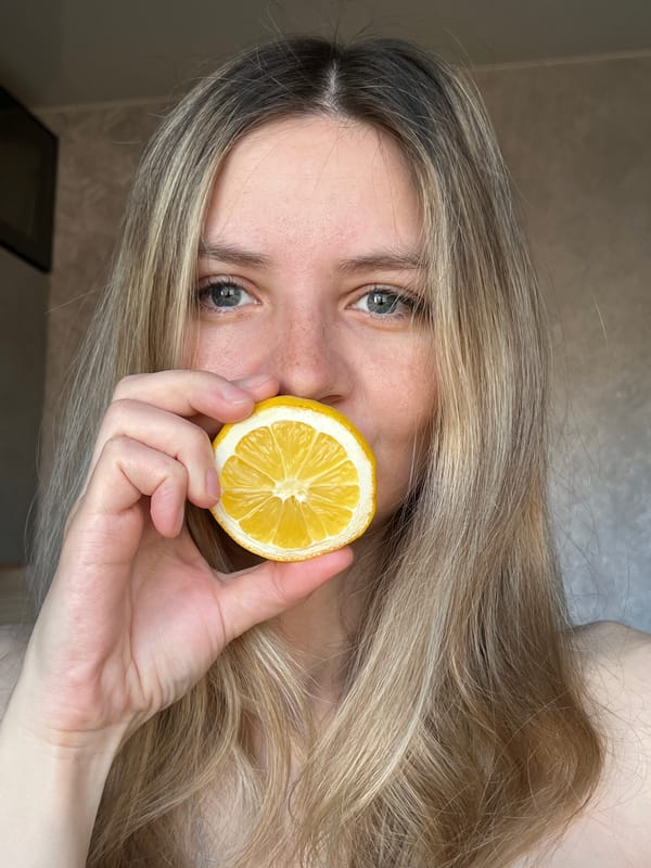 Person holds halved lemon to face in Chaikovsky, Russia