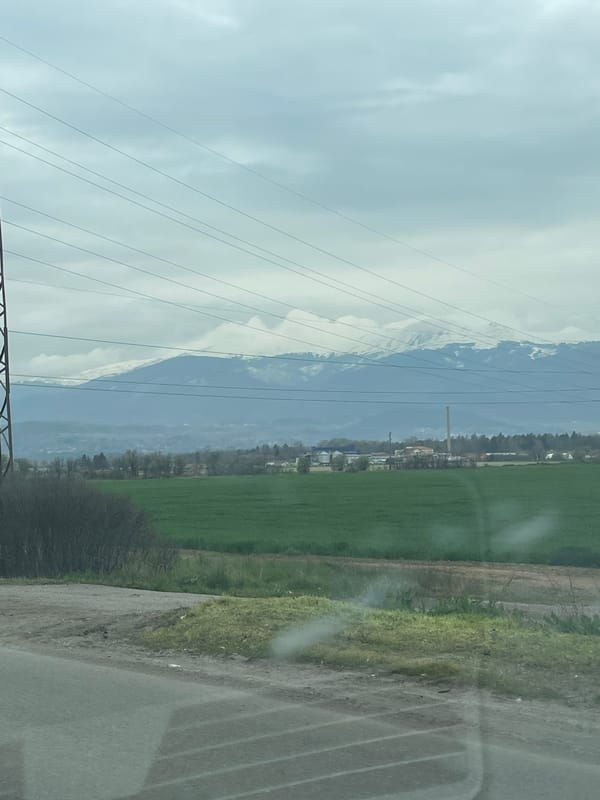Overcast skies and snow-capped peaks observed near Kazichene, Bulgaria