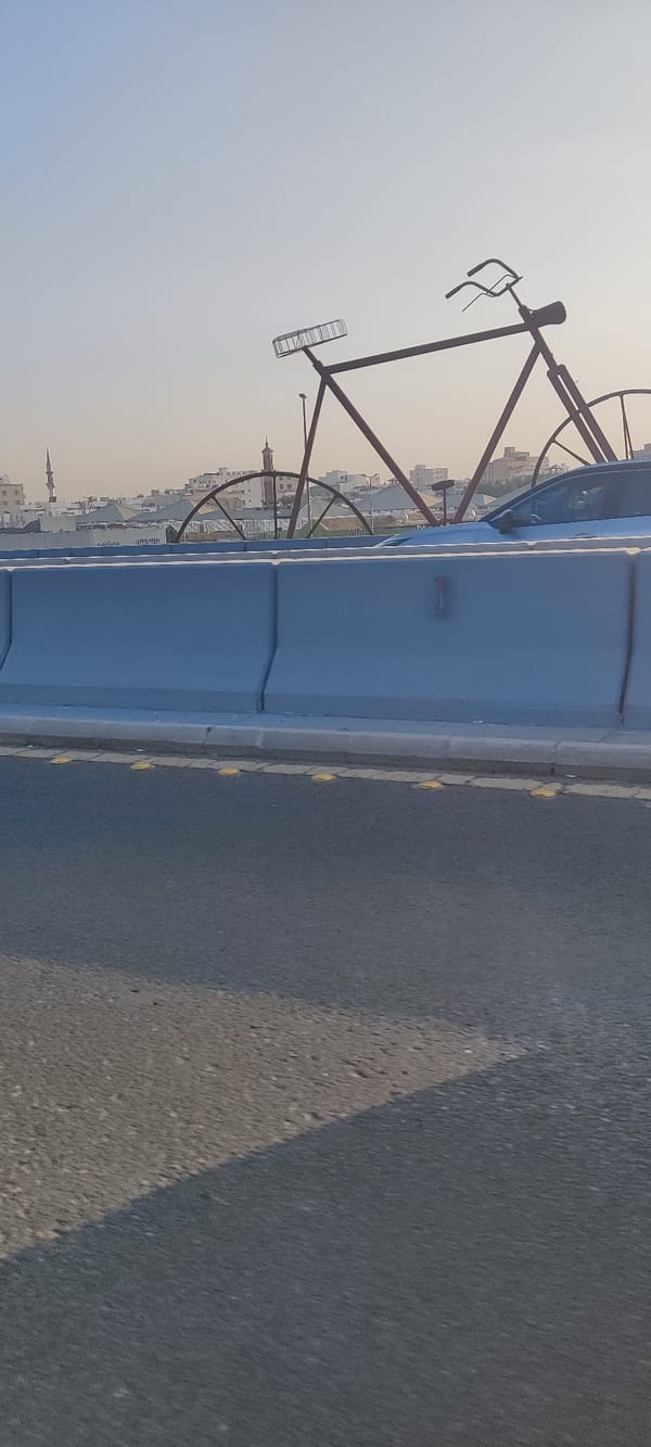Decorative bicycle sculpture spotted on Jeddah highway barrier