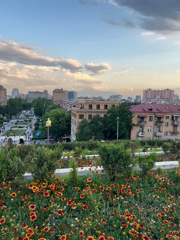 Evening at Yerevan's Cascade, flowers in bloom and city spread below