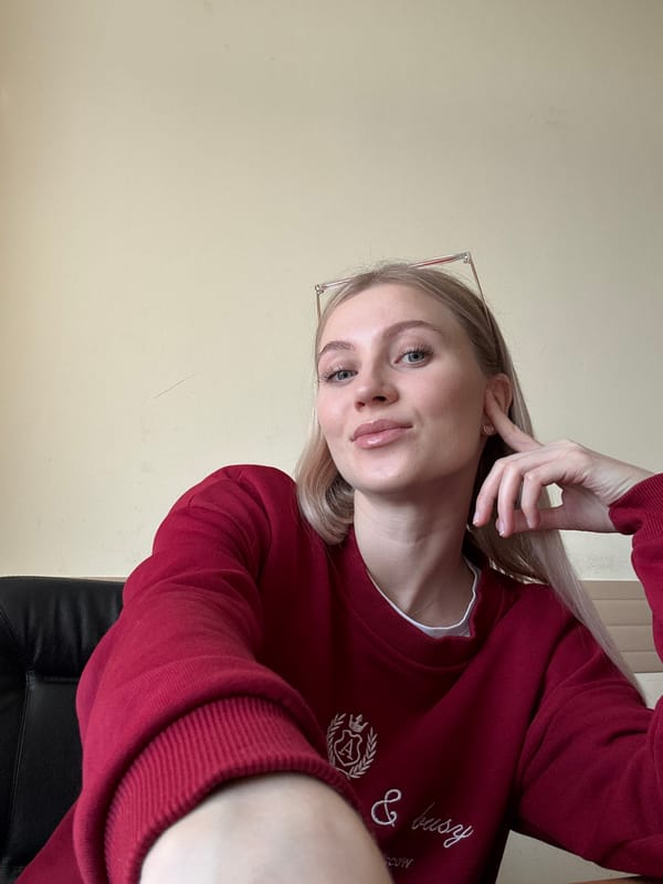 Woman takes early morning selfie in maroon sweatshirt