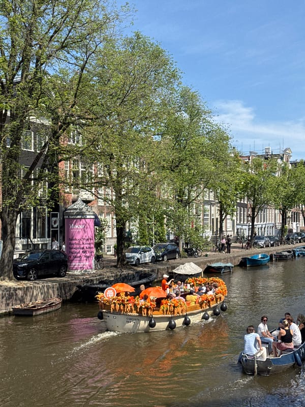 Amsterdam canal boats and Delftware shops observed midday