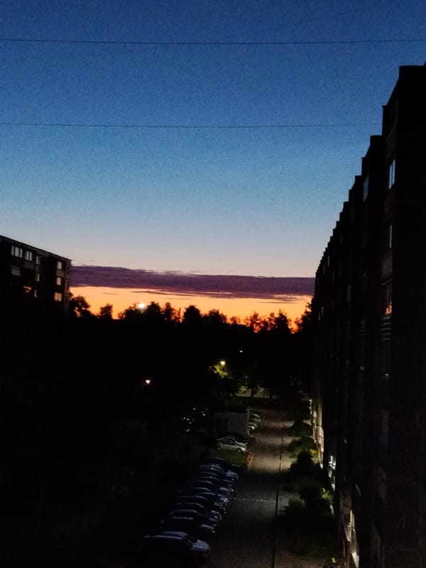 Apartment complex at dusk, aerial and ground-level views