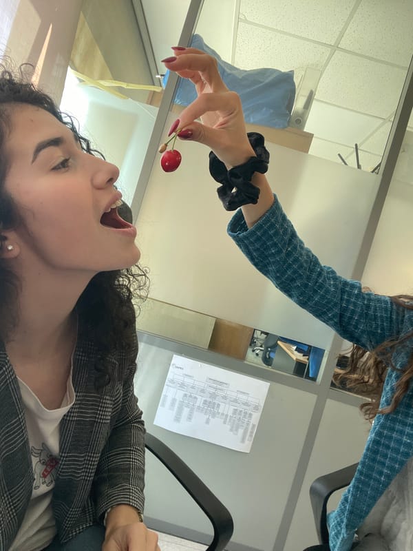 Woman enjoys cherries during office break in Sofia