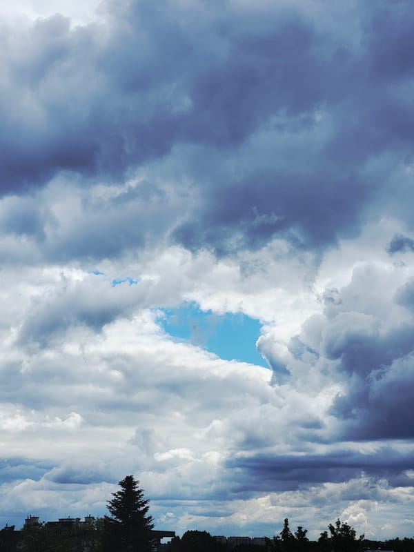 Dramatic cloudy sky over urban buildings during morning hours