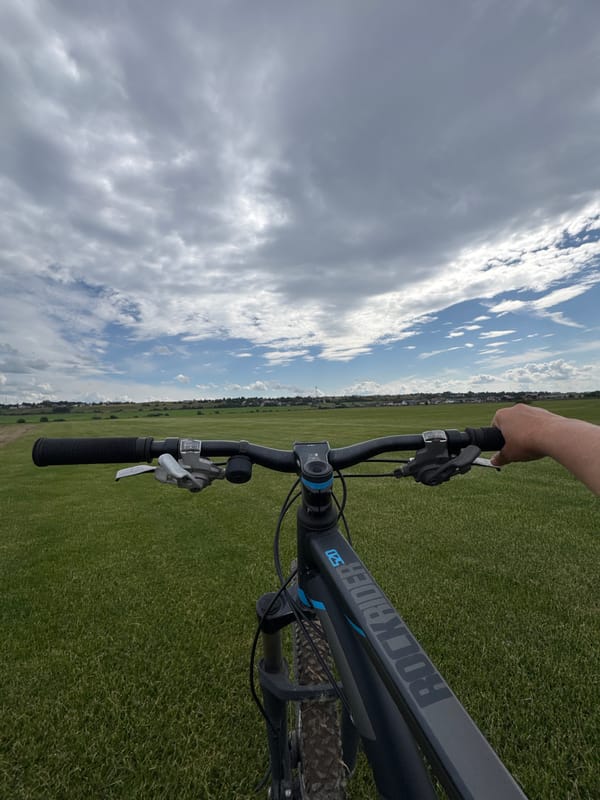 Cycling a dirt path through open fields in rural Russia