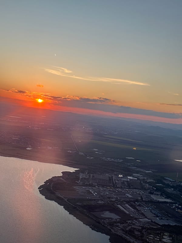 Sunset illuminates industrial waterfront area in aerial view