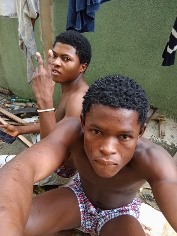 Casual morning outside a green apartment block in Ado, Nigeria
