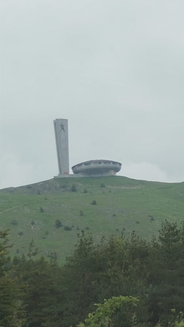 Travelers document Bulgaria's iconic Buzludzha Monument amid mountain landscapes