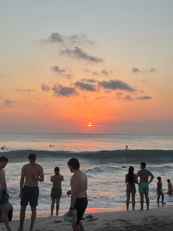 Sunset crowds gather on Kuta Selatan beach for surf and volleyball