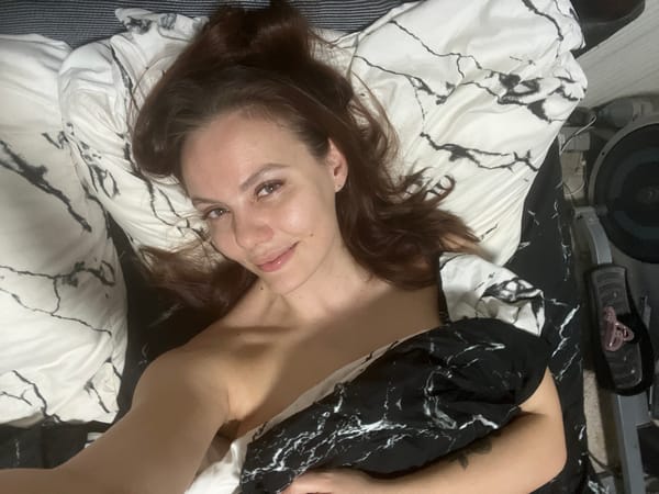 Woman takes multiple selfies in bedroom in Chaikovsky