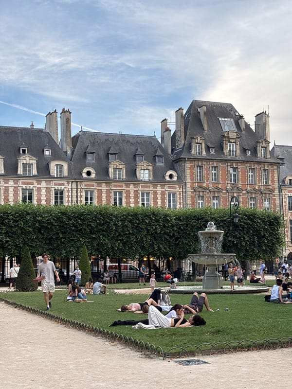 Locals and visitors unwind at Place des Vosges on a June afternoon