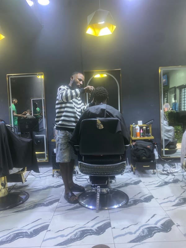 Barbershop activity documented in Lugbe, Nigeria during afternoon hours