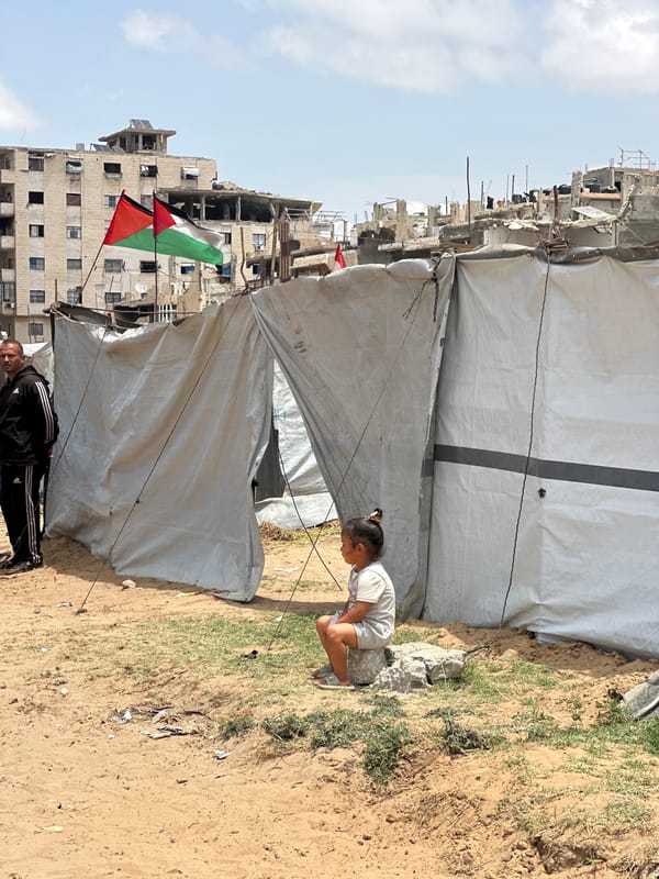 Children collect water at tent settlement in Gaza