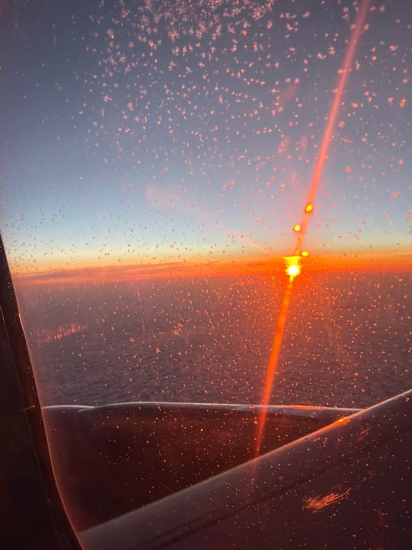Aerial witness captures brilliant orange sun view from aircraft window
