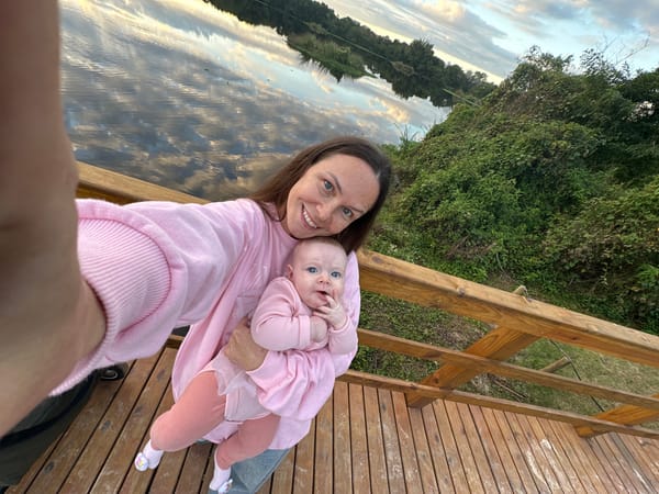 Mother and baby enjoy evening moment on Florianópolis waterfront