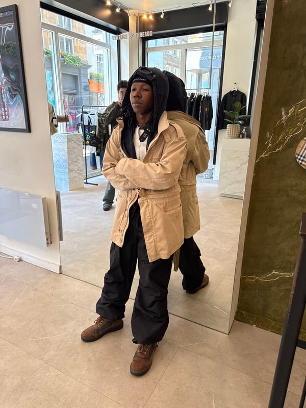 Customer tries on clothes at London vintage store