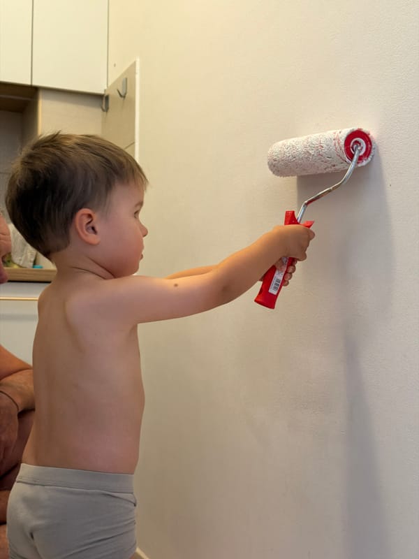Home renovation day in Budva, kid joins in on painting