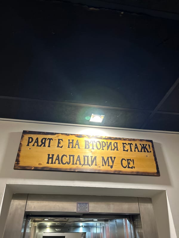 Humorous Bulgarian sign directs visitors to heaven on second floor