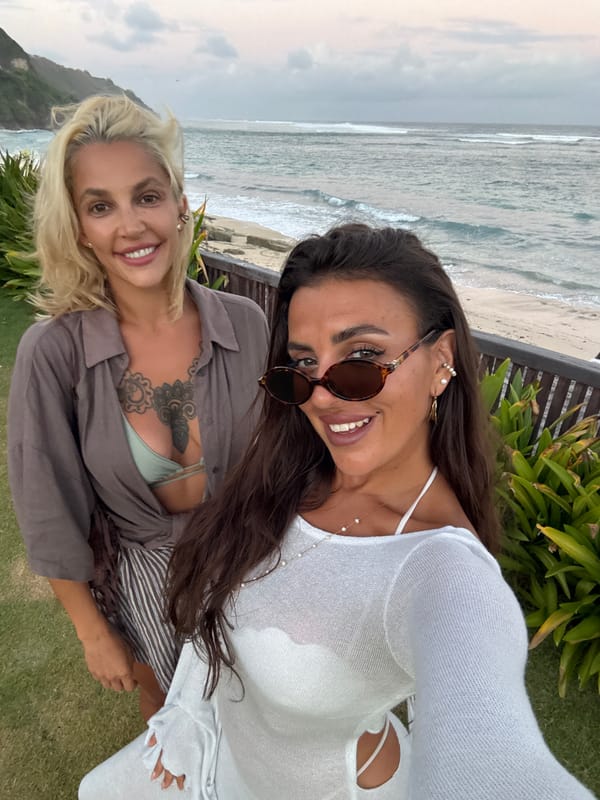 Women take beach selfies in Kuta Selatan, Indonesia