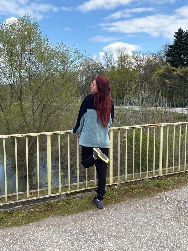 Woman stretches on bridge during overcast afternoon