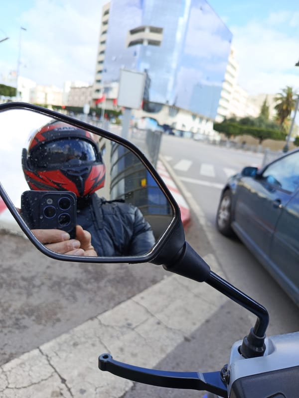 Motorcyclist takes mirror selfie on Meknes street