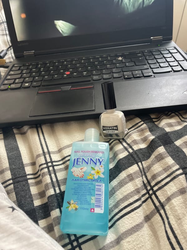 Movie streaming on a laptop alongside nail care products in Zlatograd