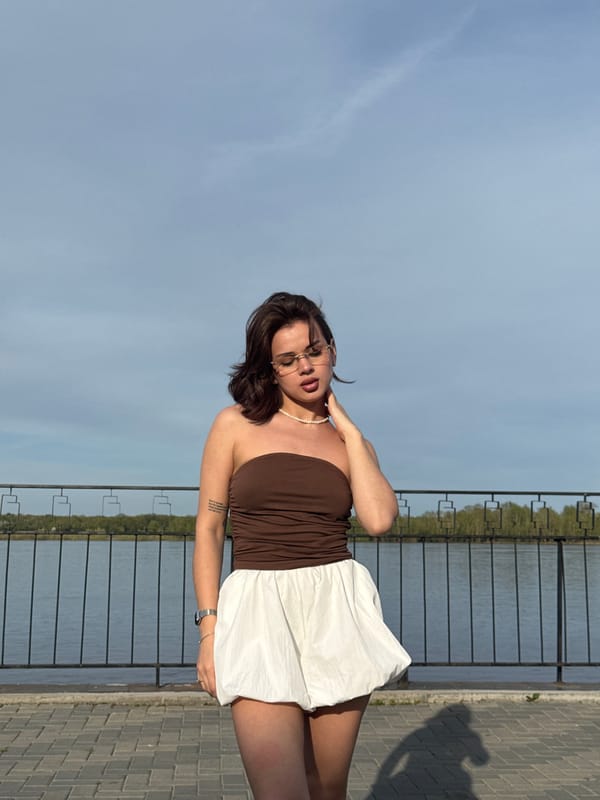 Woman poses for photos along Kama River waterfront in Sarapul