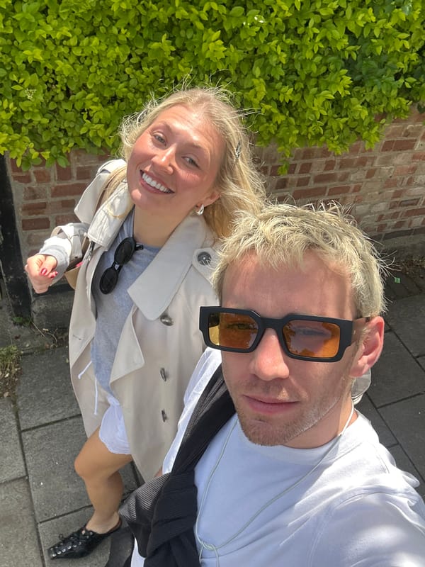 Couple taking selfies on London sidewalk