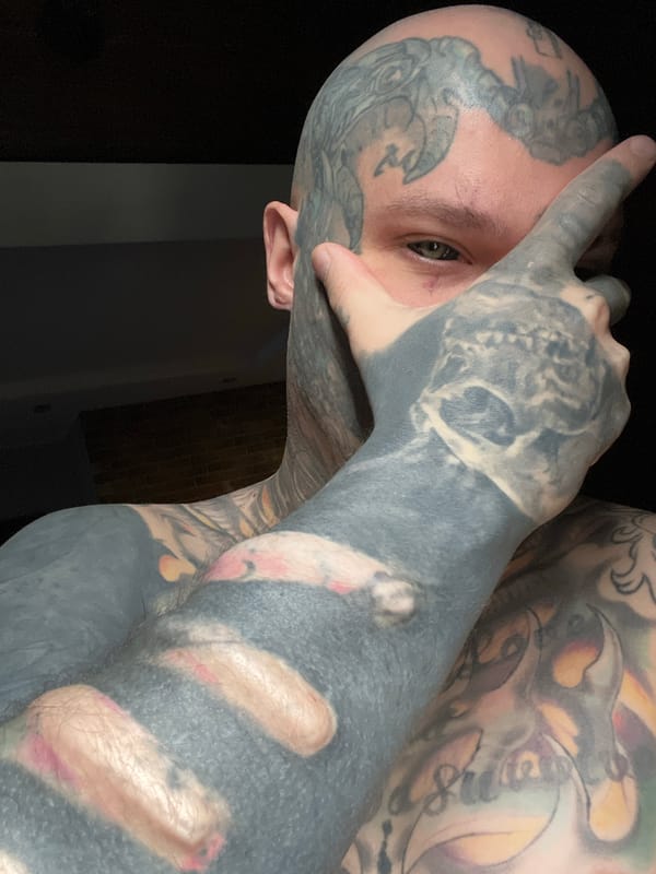Heavily tattooed person photographed in Kudrovo, Russia