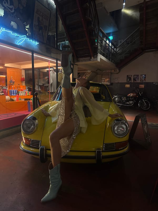 Bold fashion pose on a vintage yellow car in Bangkok.