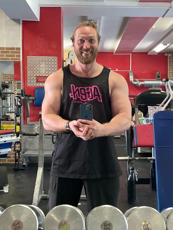Gym selfie at a brick-walled weightlifting spot in St. Petersburg