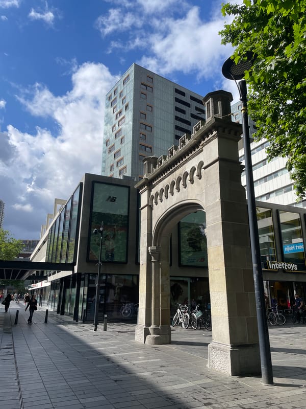 Morning street scene documented in Rotterdam featuring tram, architecture