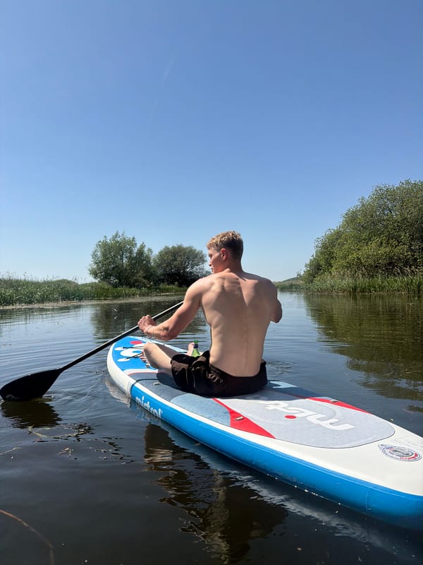 Man paddleboards on River Stour in Babergh