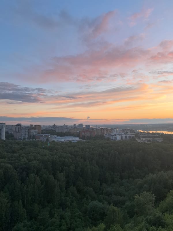 Sunset captured over Perm skyline from forested viewpoint