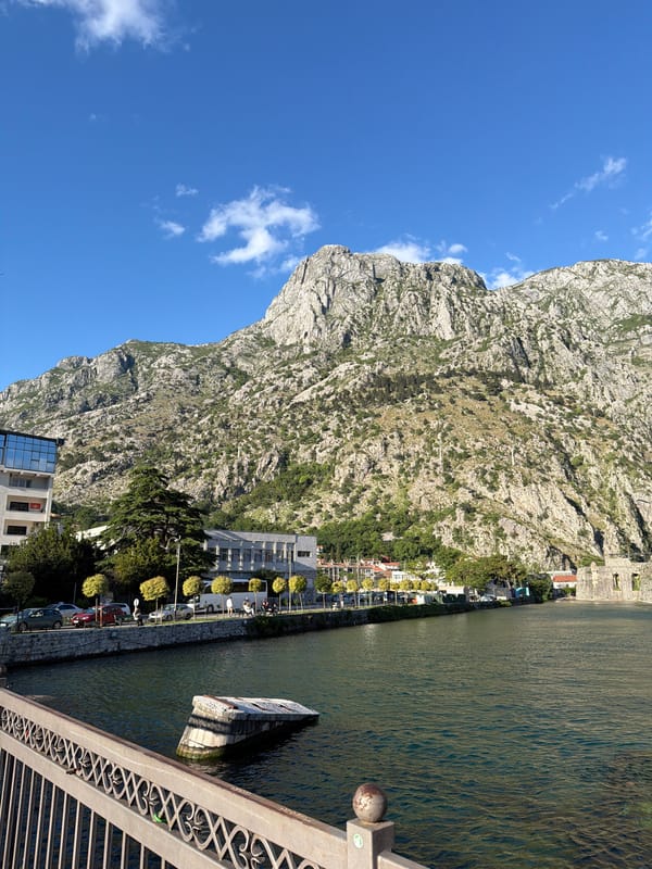 Clear skies showcase Kotor's historic mountains and fortifications