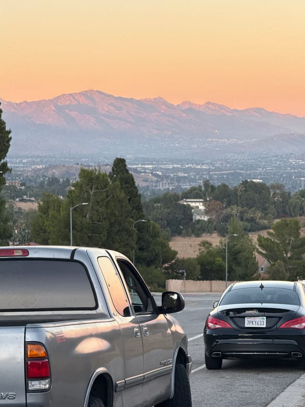 LA hillside views at dusk, valley sprawl and mountains
