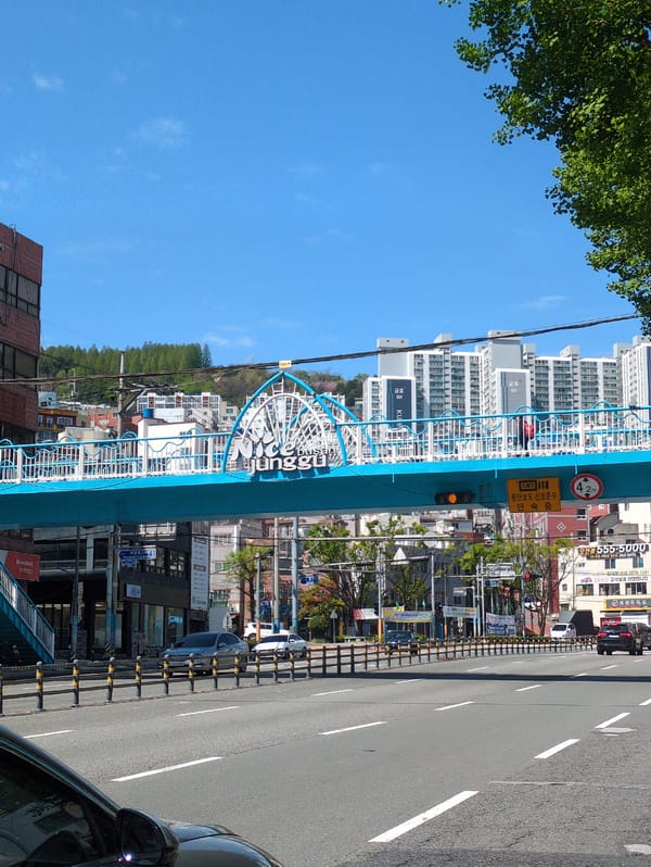 Tourist documents spring morning walk through central Busan landmarks