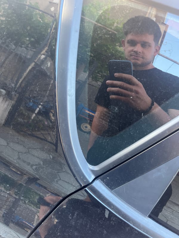 Car maintenance and romantic balloon display captured in Bulgarian village