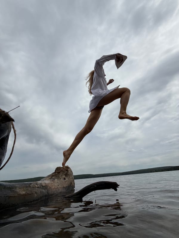 Woman photographed leaping from tree trunk in Chaikovsky, Russia