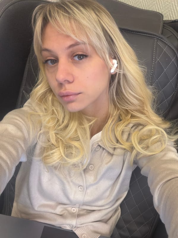 Woman rests in leather chair with laptop in Moscow