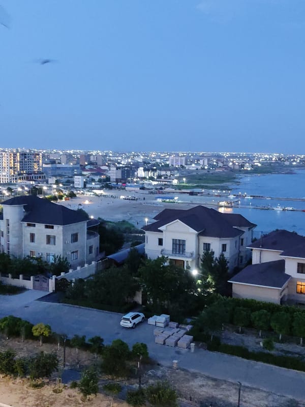 Aerial dusk views over a quiet coastal neighborhood