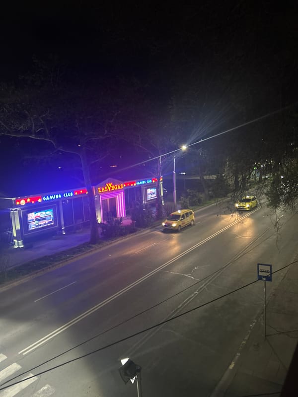 Nighttime street scene captured in Plovdiv featuring gaming club signage