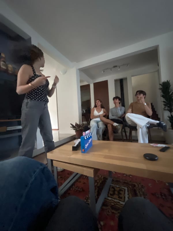 Five people gather casually in Cholula home