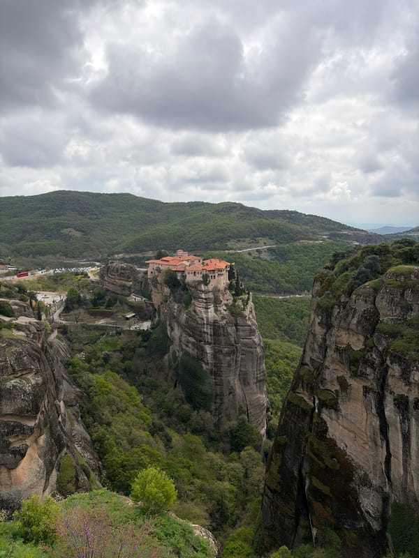 Tourist captures Meteora monastery views and orange cat in Greece