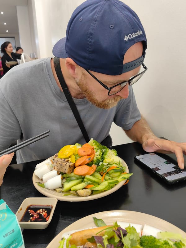 Diner uses smartphone during meal at Vietnam restaurant