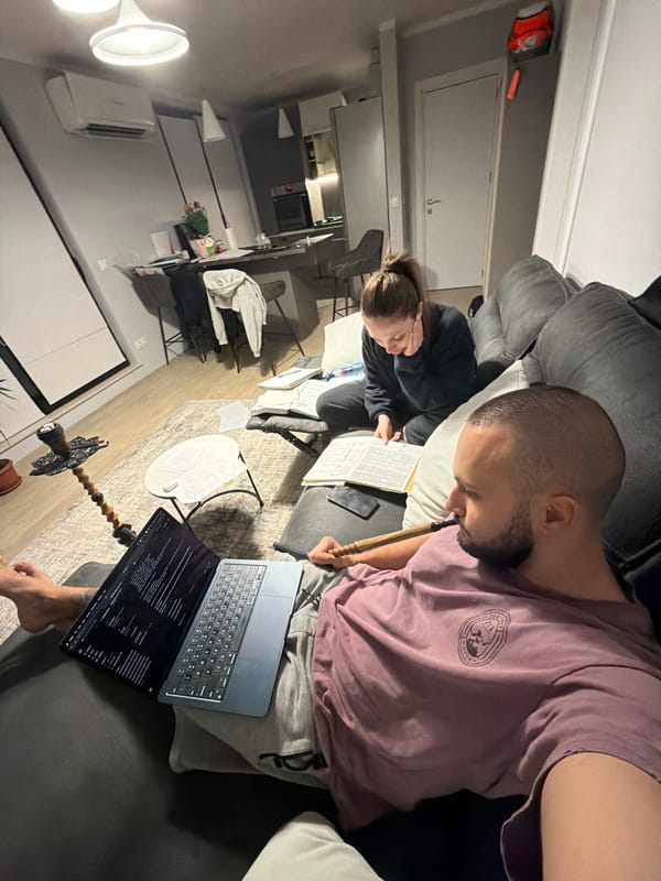Two people relax on sofa in Sofia apartment